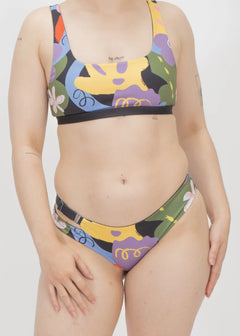 Colorful abstract patterned bikini swimsuit with geometric shapes and designs.