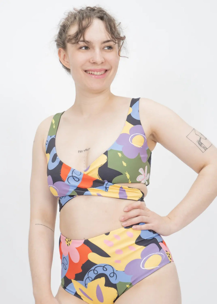 Colorful abstract patterned two-piece swimsuit with high-waisted bottoms and crop-style top.